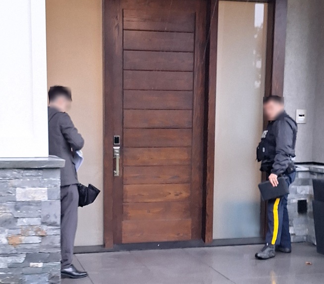 Police standing at a front door