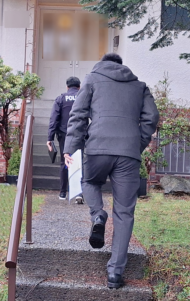 A BCSC investigator and an RCMP officer pay a visit to a suspected money mule