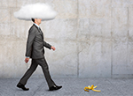 Man walking down a sidewalk with a cloud covering his head