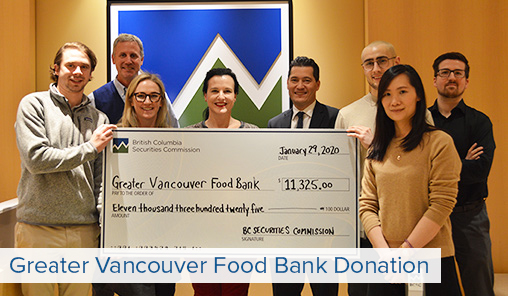 BCSC staff members pose with a large cheque for the food bank